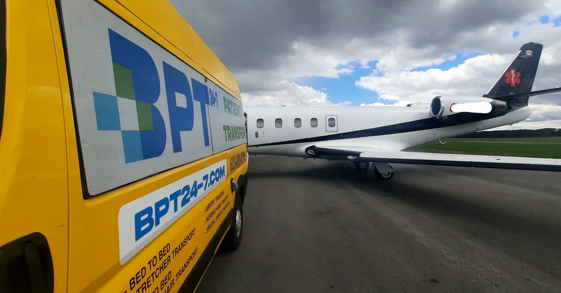 BPT24-7 stretcher van staged on the tarmac next to a medical air-ambulance jet at Ottawa International Airport (YOW)